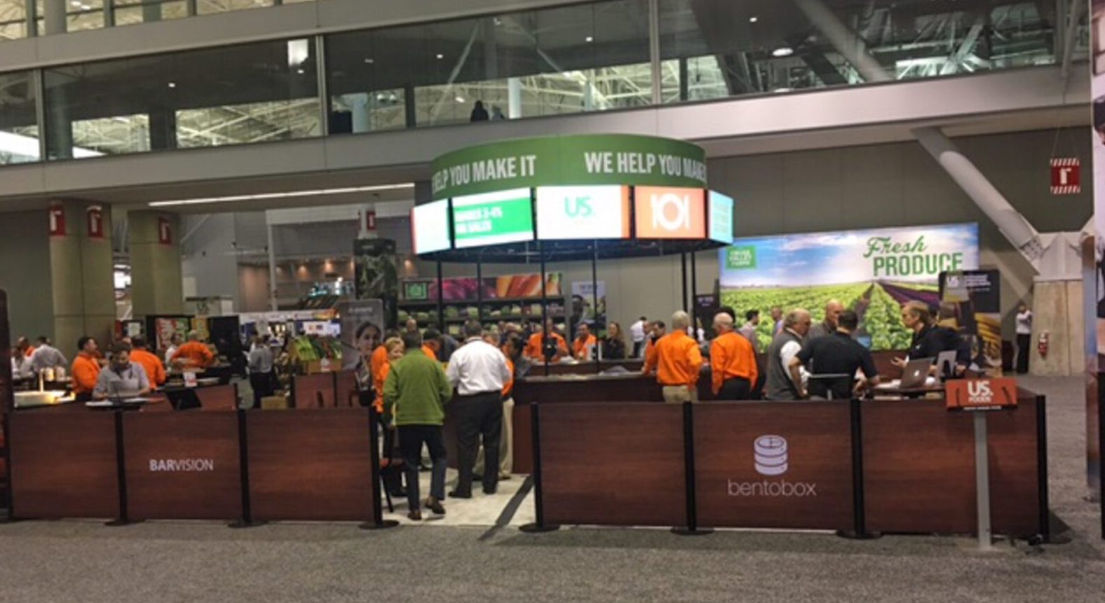 SEG US Foods Round Multiple TV Mount with tubular signage and crowd control double-sided graphics to enclose trade show booth