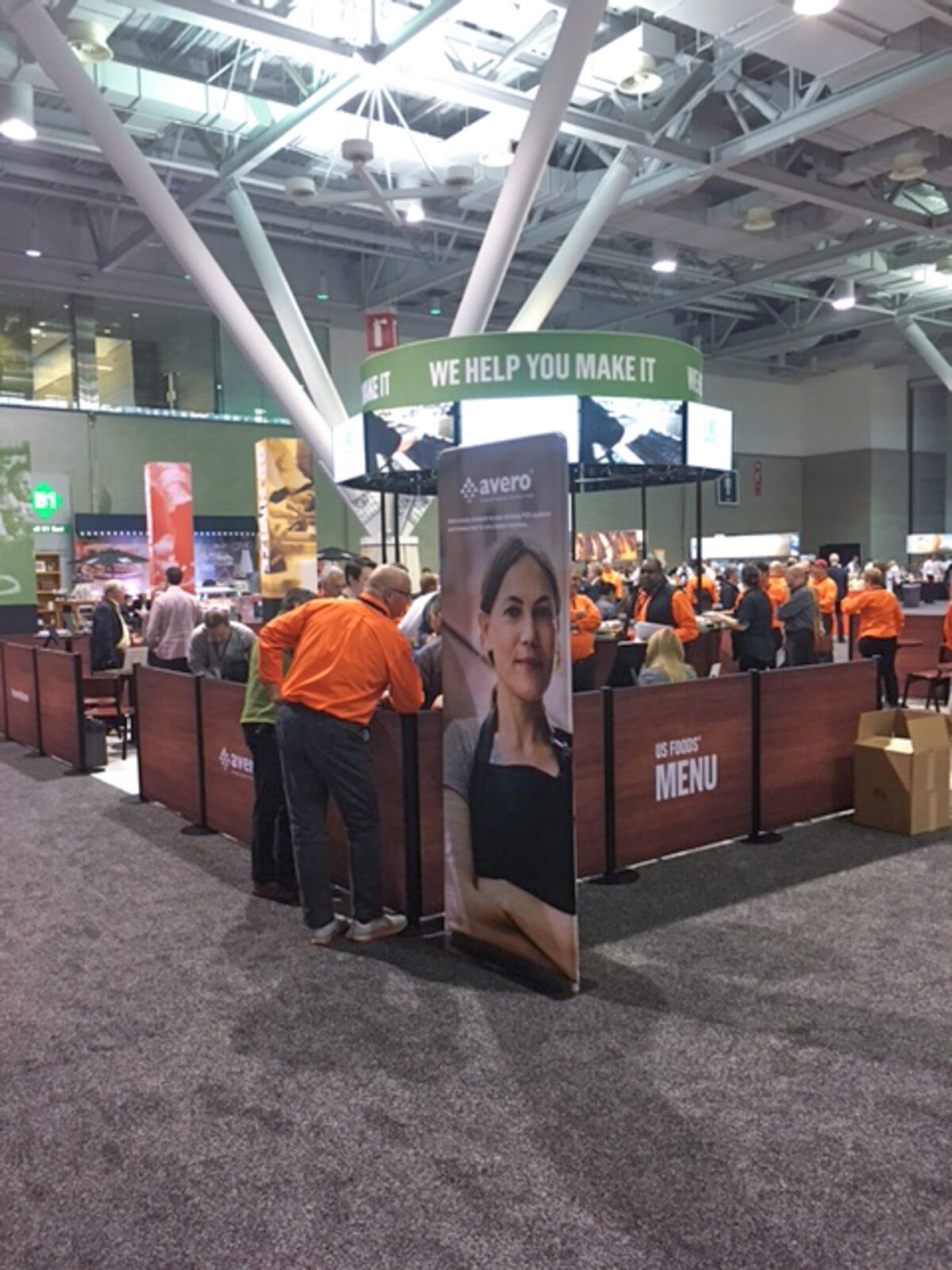 SEG US Foods Round Multiple TV Mount with tubular signage and crowd control double-sided graphics to enclose trade show booth