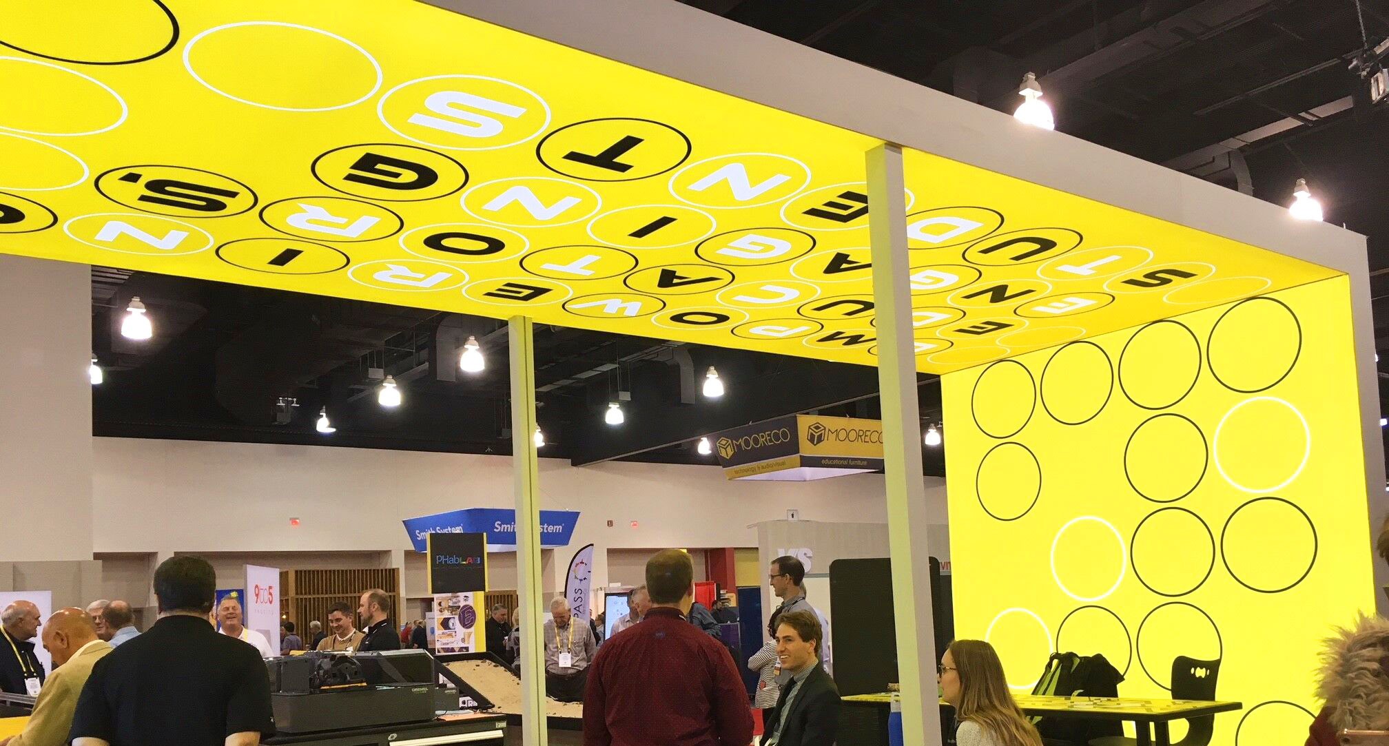 Palmer Hamilton Trade Show Booth that uses freestanding and arched lightboxes to create an environment