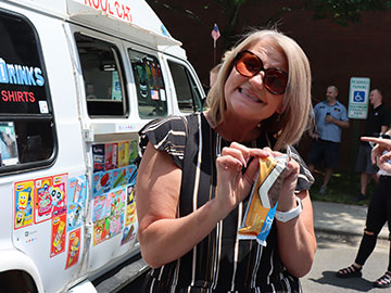 An SEG employee smiling while holding ice cream