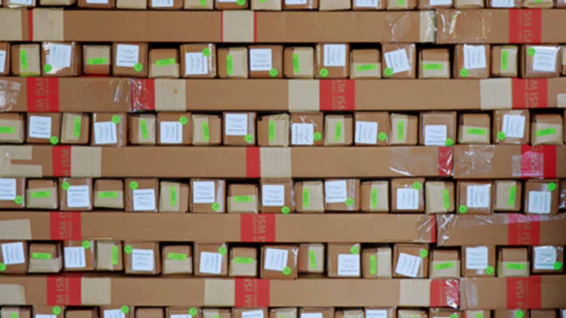 boxes of extrusions with red and green stickers