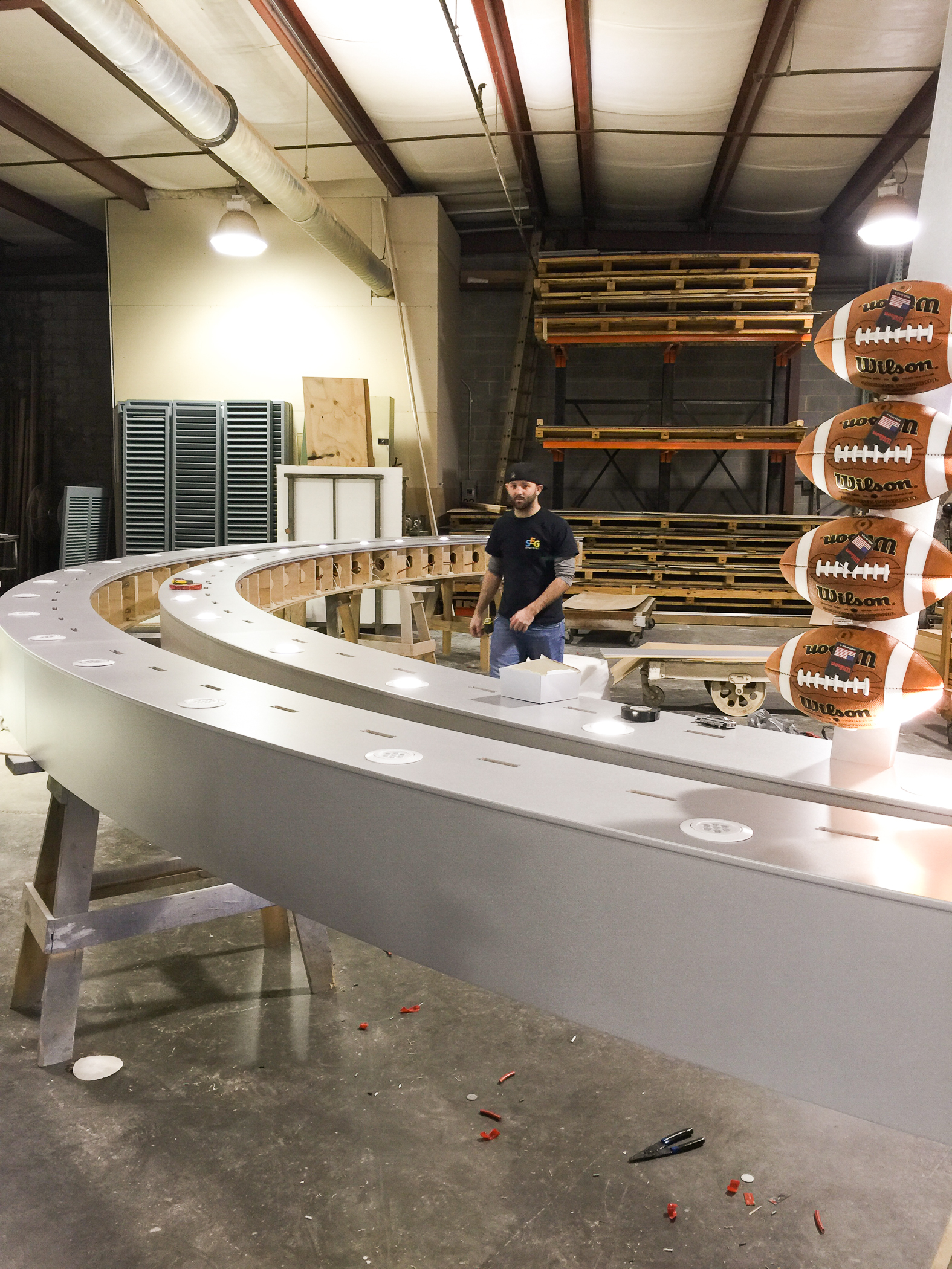 curved millwork football install in production